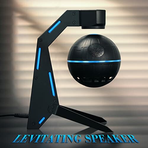 Levitating speaker with futuristic design on stand.