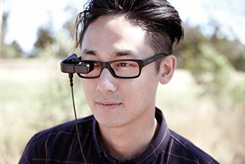 Man wearing smart glasses with a small display attachment.